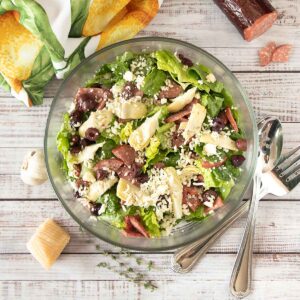 With a flavorful vinaigrette, artichokes, parmesan, olives and summer sausage, this Spicy Italian Salad is full of flavor.