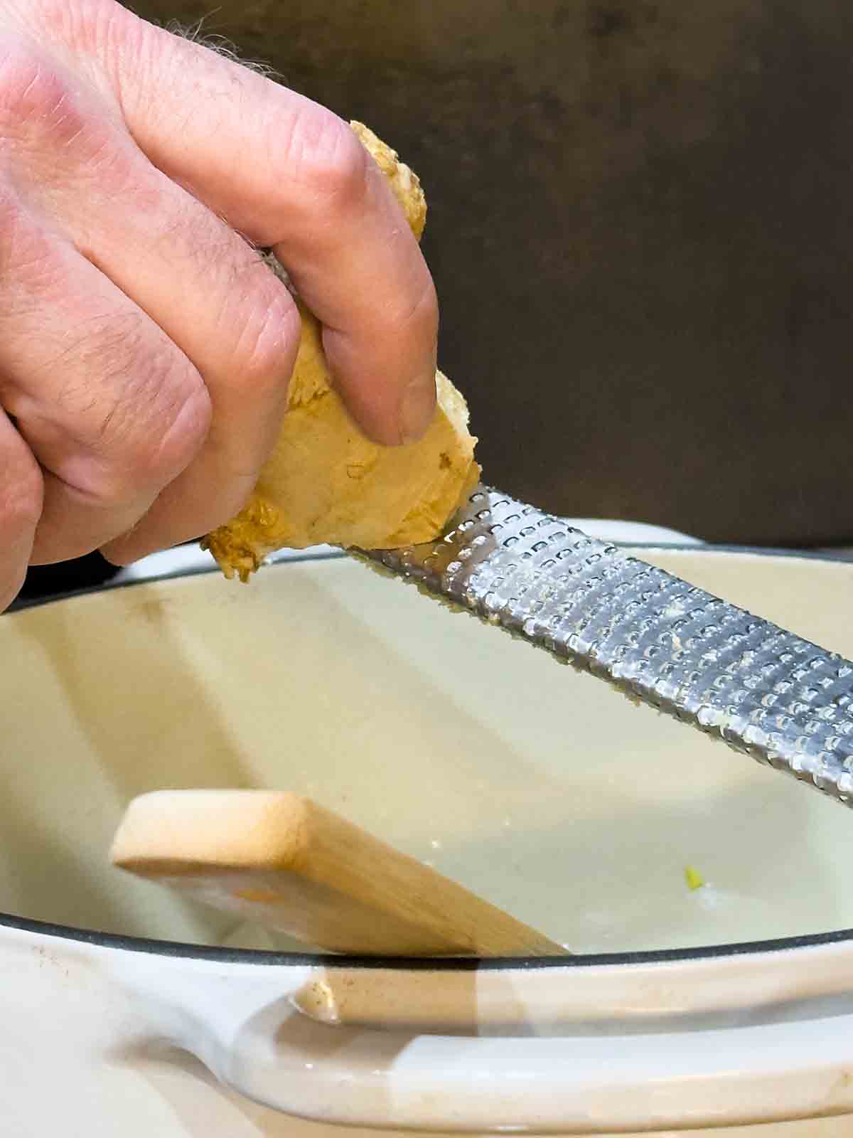 adding grated ginger