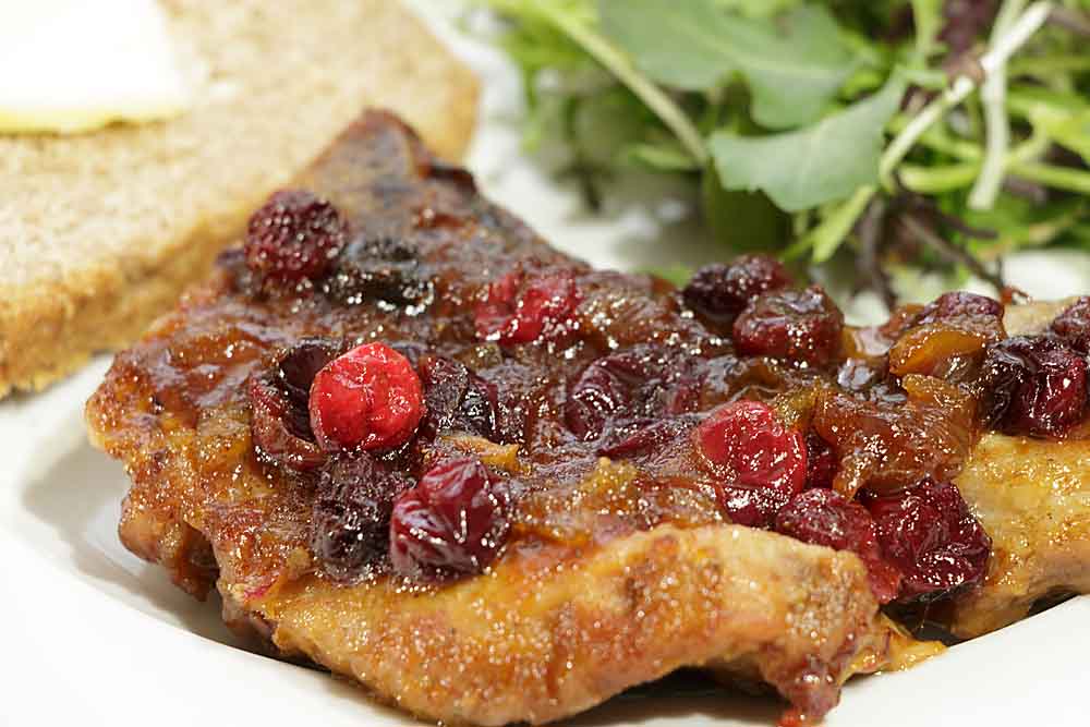 Cranberry Glazed Pork Chops are elegant and "comfy" at the same time. The savory pork and glistening berries make it a perfect dish for Valentine's Day or Christmas dinner. 