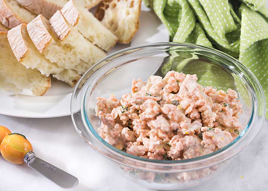 Salmon with Capers is a quick and elegant appetizer or light sandwich topper. Poach salmon and combine with a mayonnaise and caper dressing ahead of time, then serve when needed.