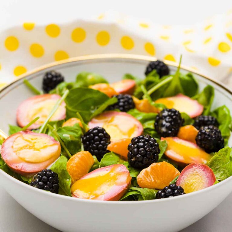 Brighten your day with this Colorful Spring Salad full of vibrant fruits, lettuce & pink pickled eggs. A tasty first course or light entree.