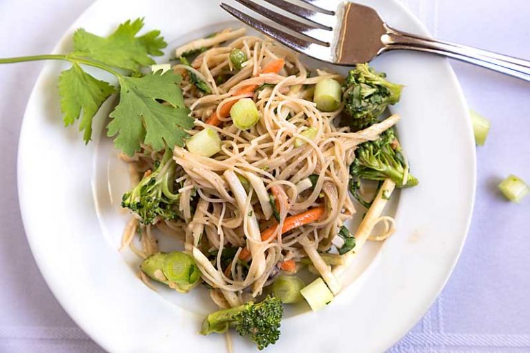 Peanut-y with a hint of spice, Thai Noodle and Vegetable Salad combines brown rice noodles, chopped vegetables and a spicy sauce.