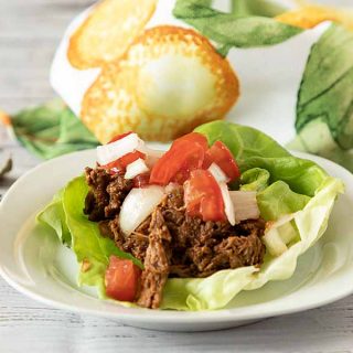 Slow Cooker or Dutch Oven Shredded Beef Barbacoa has loads of flavor & a little kick. Stuff tacos or lettuce leaves for a low-carb, gluten-free meal. 