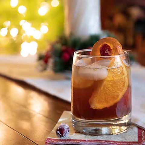 This Wisconsin Old-Fashioned recipe uses pomegranate molasses instead of cherries with a cranberry garnish for a holiday flair. Cheers!