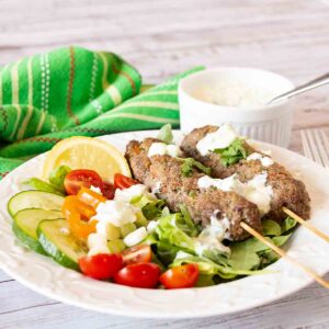 A green salad topped with spiced beef sausage kebabs, Kefta Salad with Tzatziki Dressing is a tasty and unique main course salad. Just add pita.