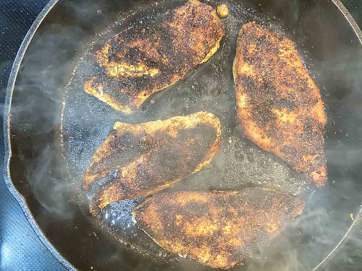 Blackened chicken in pan