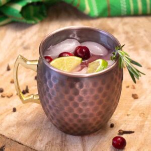 Flavored with cranberry juice, ginger beer, lime and vodka, the Cranberry Moscow Mule is a fun and tasty holiday cocktail. 