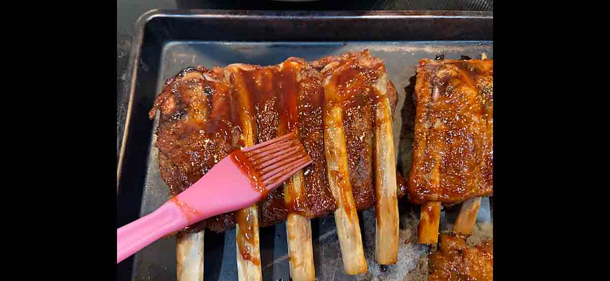 Brush slow cooker ribs with BBQ sauce