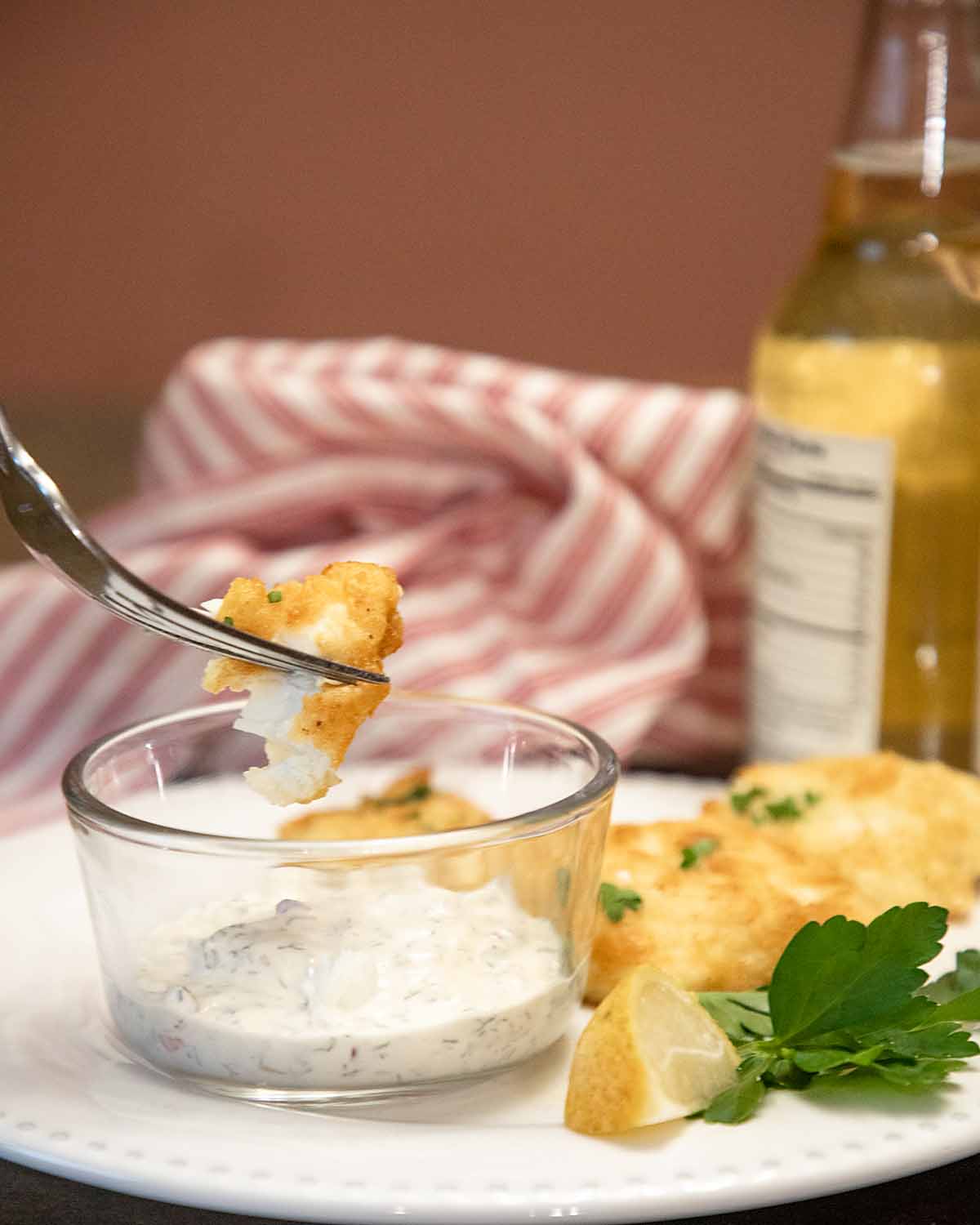 dipping fish in tartar sauce