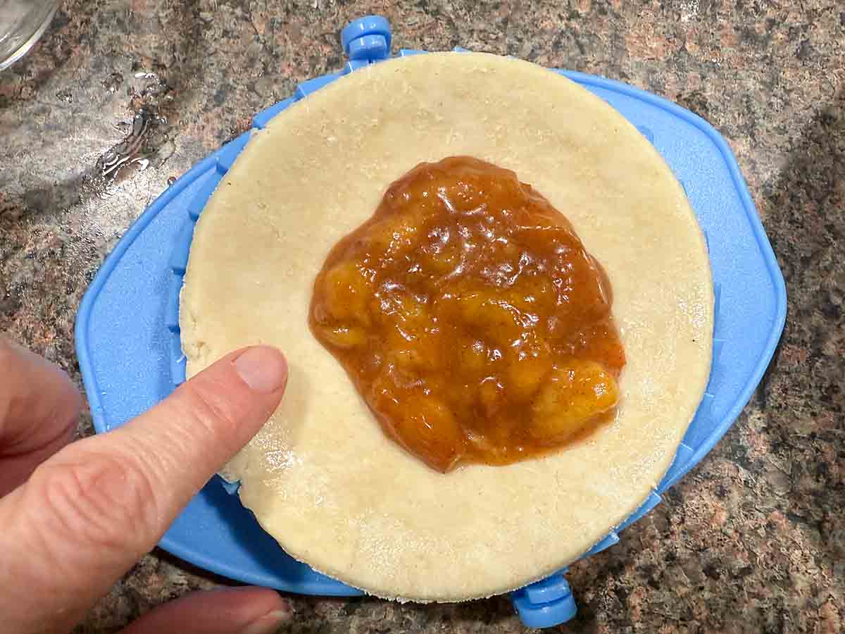 place a spoonful of filling on dough circle