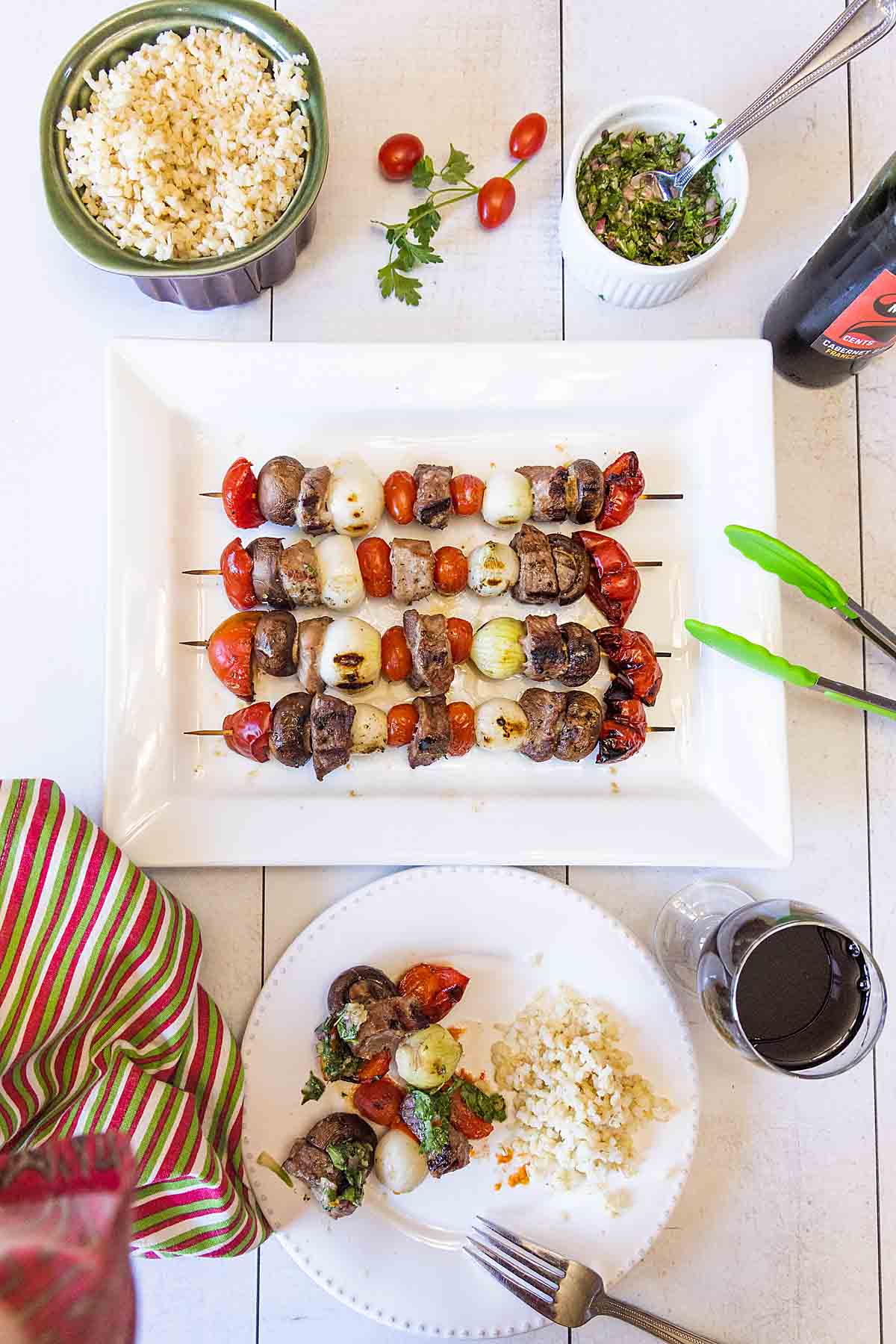 Pork kabobs with chimichurri sauce, served