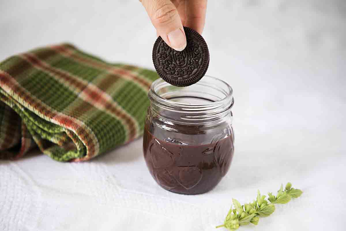 dipping oreo in chocolate fudge sauce