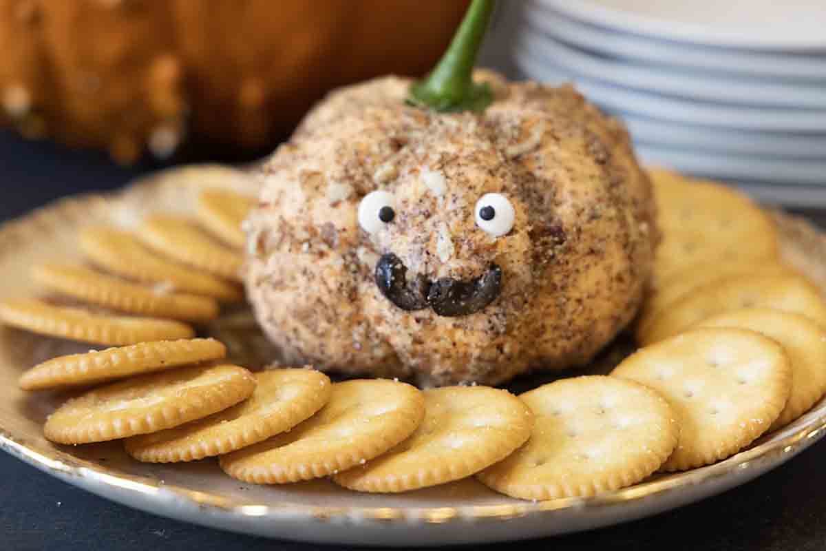 CHeese Ball with google eyes and smile that looks like a mustach