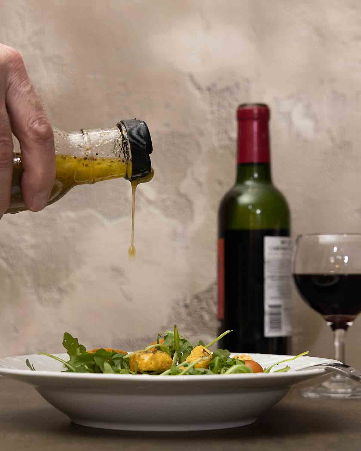 Pouring dressing on salad