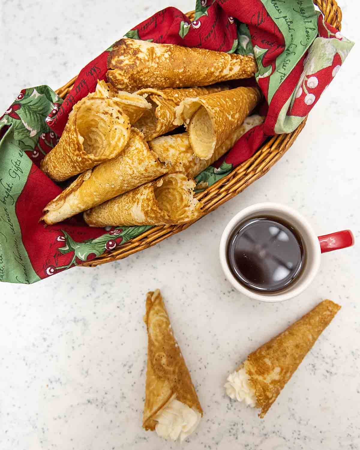 Norwegian Krumkake in a basket and two with whipped cream
