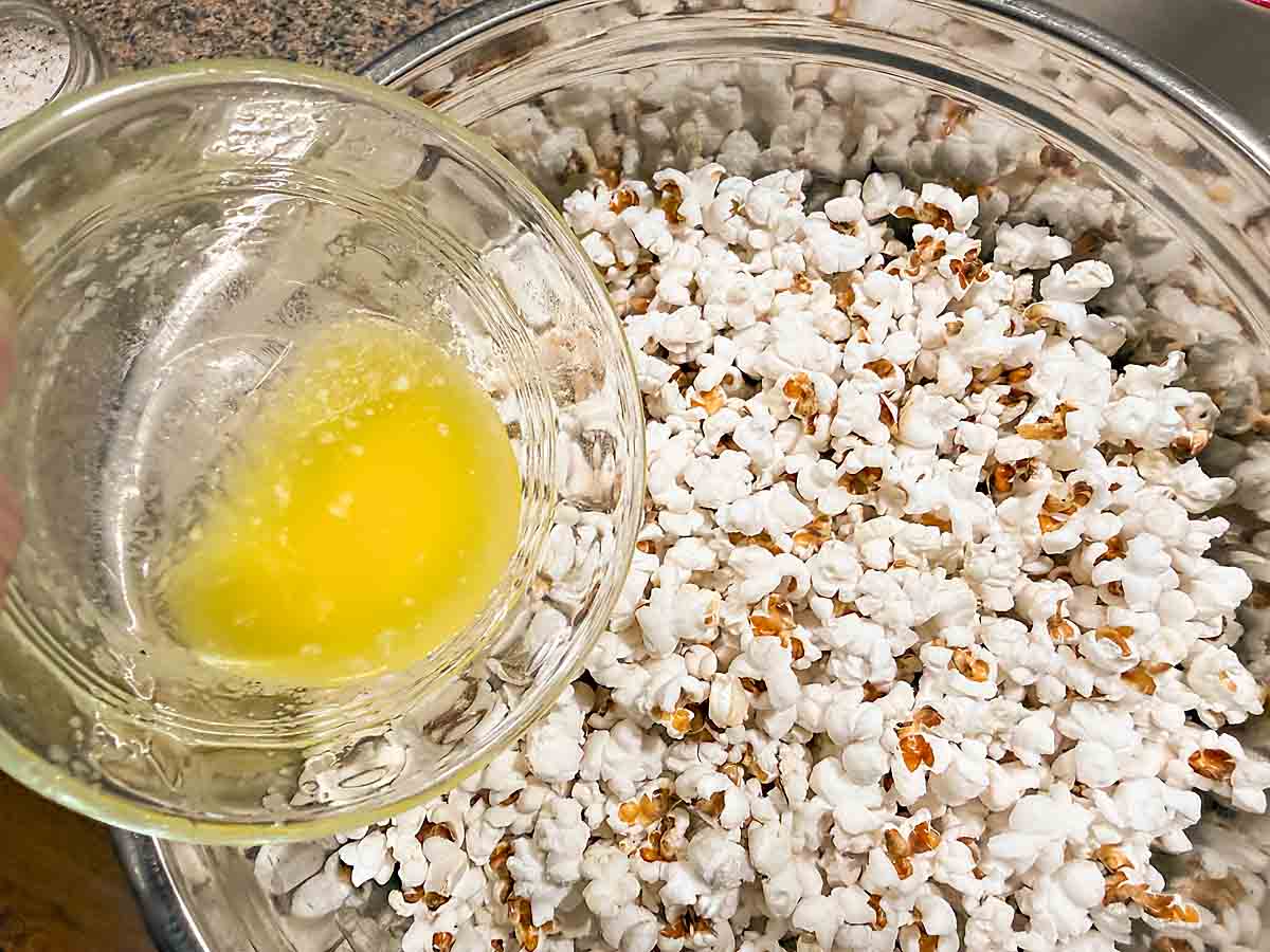 toss butter and oil mixture with popcorn