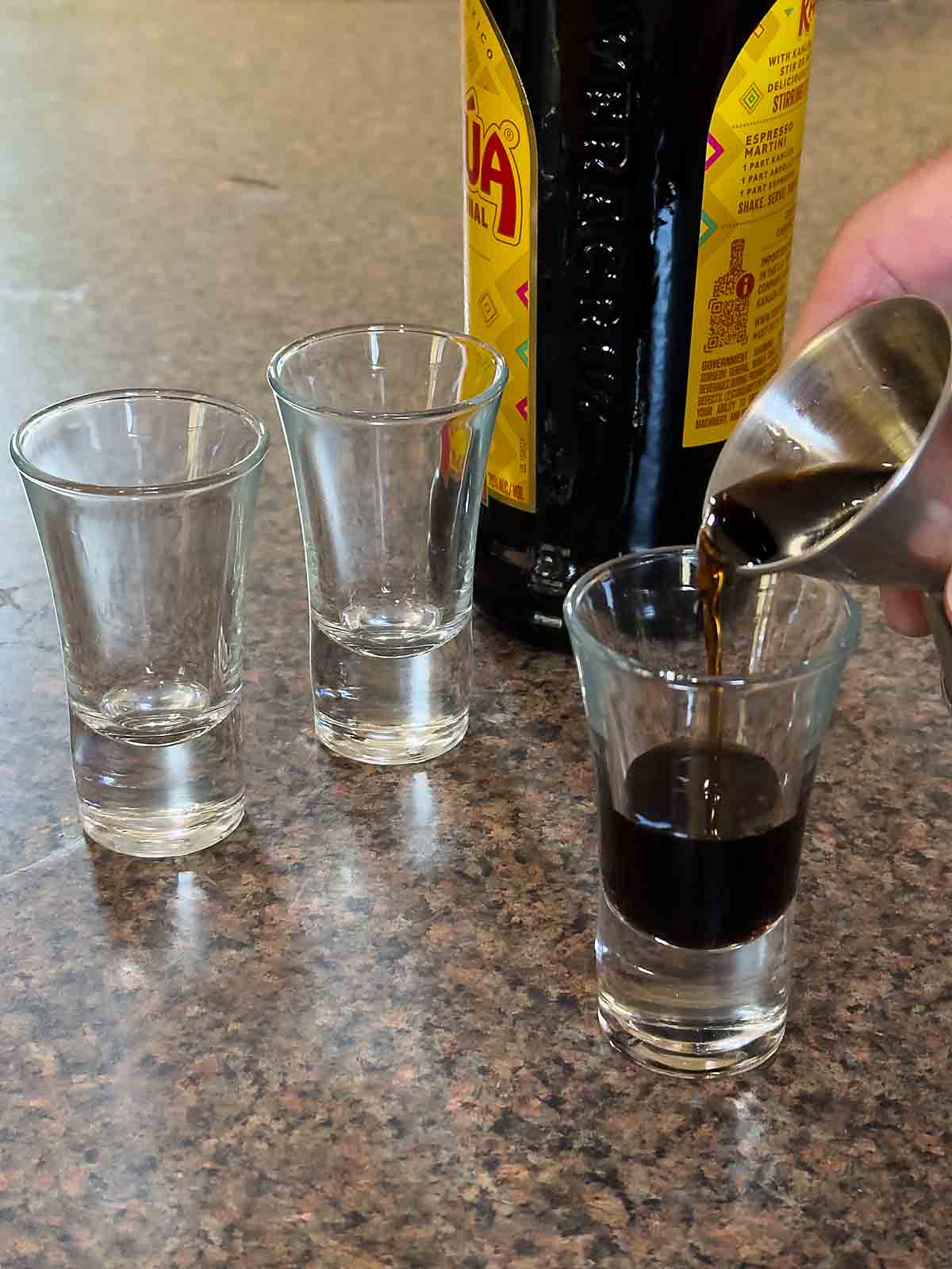 pour Kahlua in shot glass
